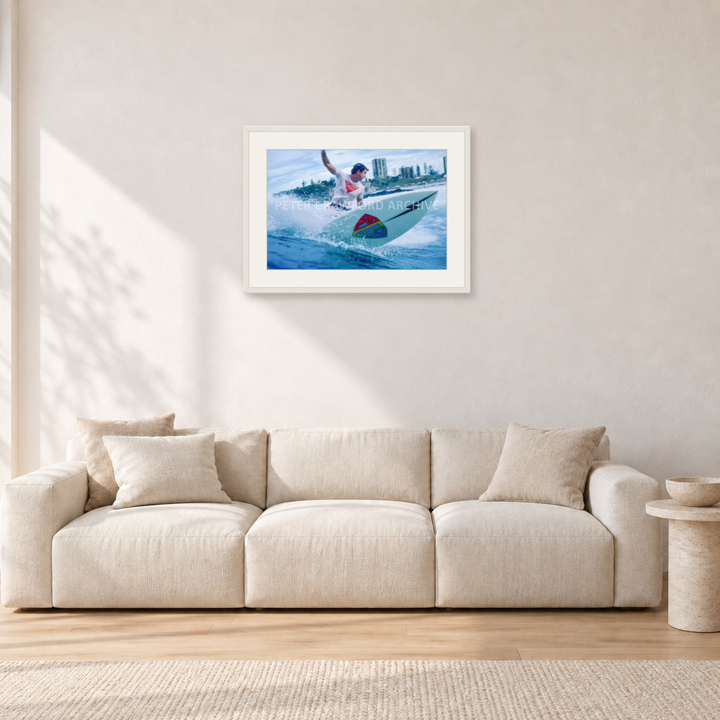 Mark Richards, Snapper Rocks by Peter Crawford — 60 × 40 cm, white frame with white mat, shown in a light minimalist living room.