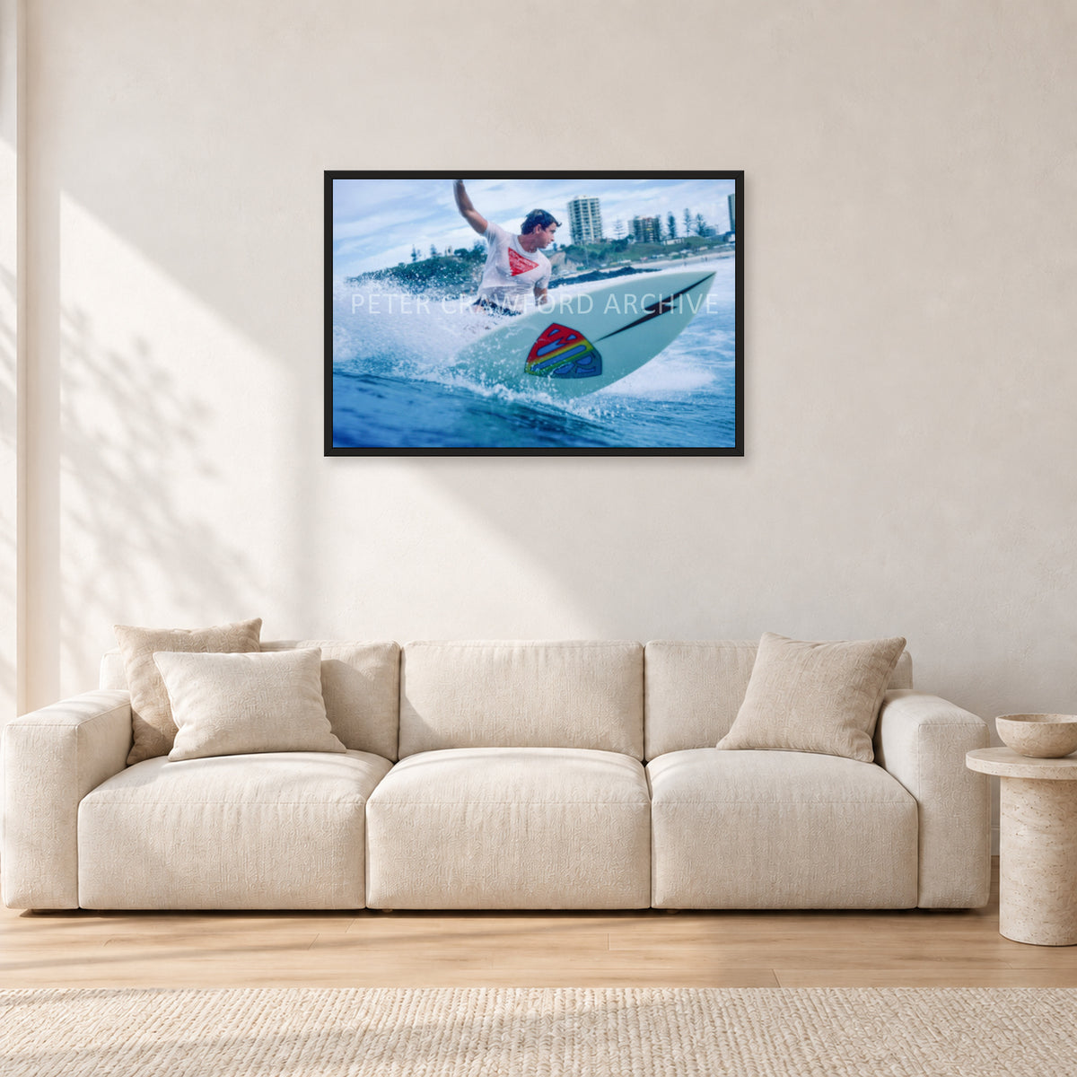Mark Richards, Snapper Rocks by Peter Crawford — 90 × 60 cm, black frame, shown in a light minimalist living room.