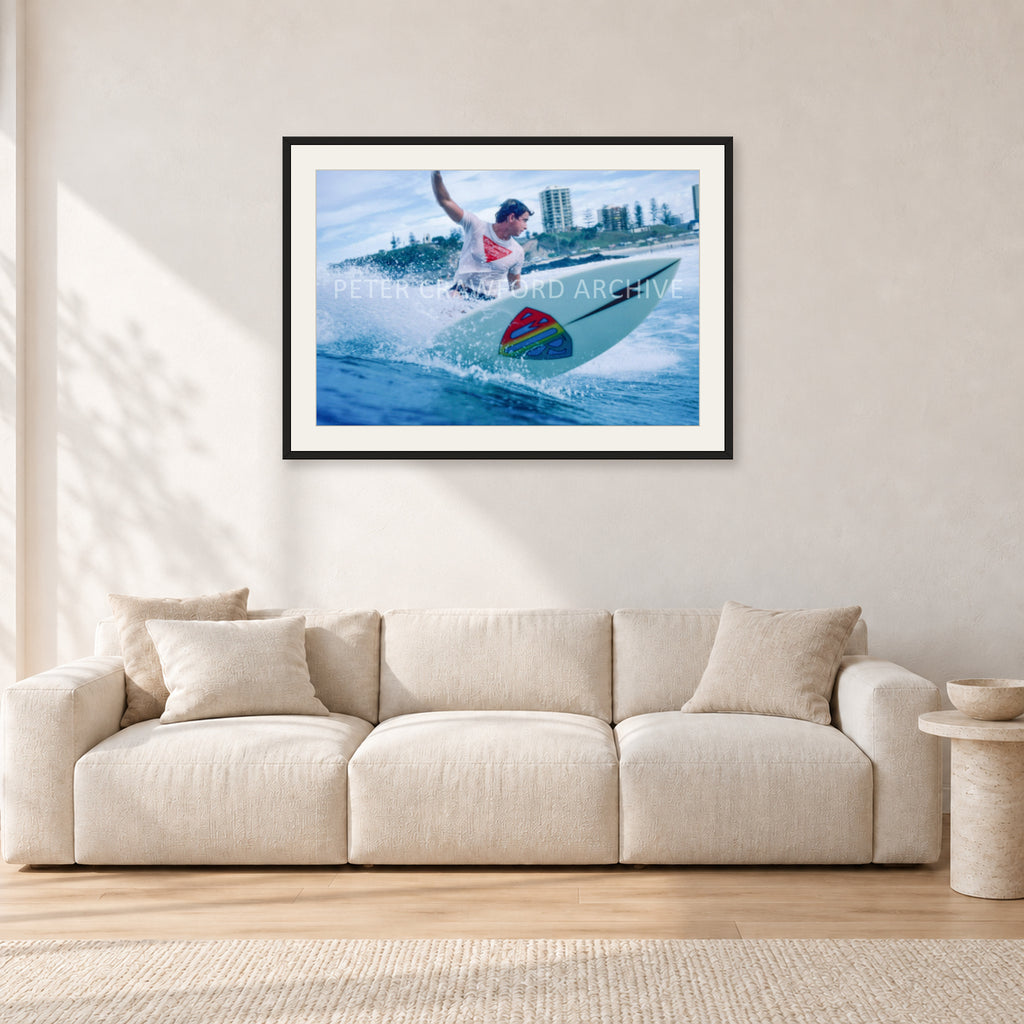Mark Richards, Snapper Rocks by Peter Crawford — 90 × 60 cm, black frame with white mat, shown in a light minimalist living room.
