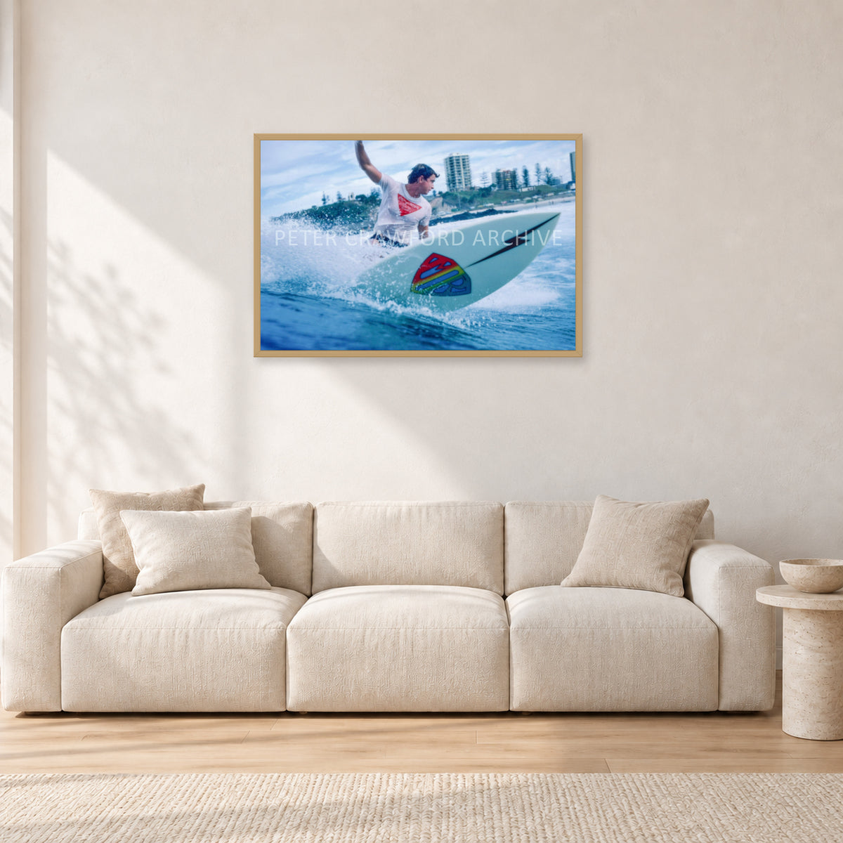 Mark Richards, Snapper Rocks by Peter Crawford — 90 × 60 cm, hayseed frame, shown in a light minimalist living room.