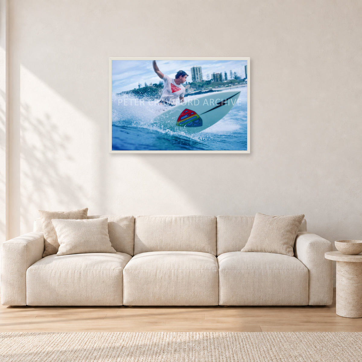 Mark Richards, Snapper Rocks by Peter Crawford — 90 × 60 cm, white frame, shown in a light minimalist living room.