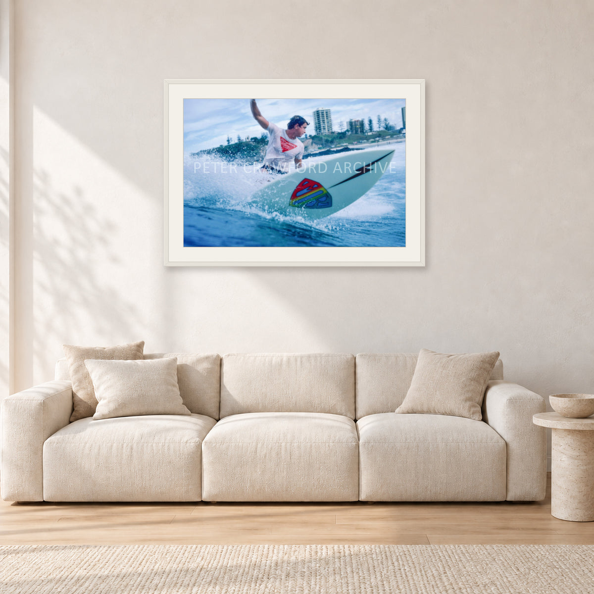 Mark Richards, Snapper Rocks by Peter Crawford — 90 × 60 cm, white frame with white mat, shown in a light minimalist living room.
