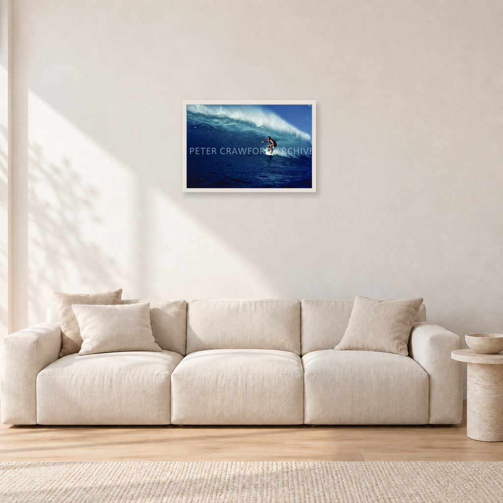 Michael Peterson, Sunset Beach 1975 by Peter Crawford — 60 × 40 cm, white frame, shown in a light minimalist living room.