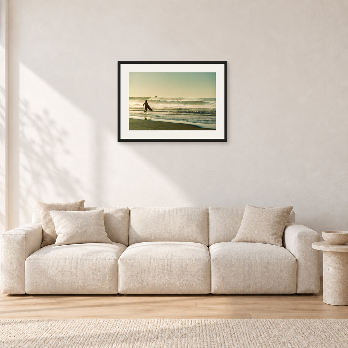 Narrabeen Surfer Fish, Dawn 1991 by Peter Crawford — 60 × 40 cm, black frame with white mat, shown in a light minimalist living room.
