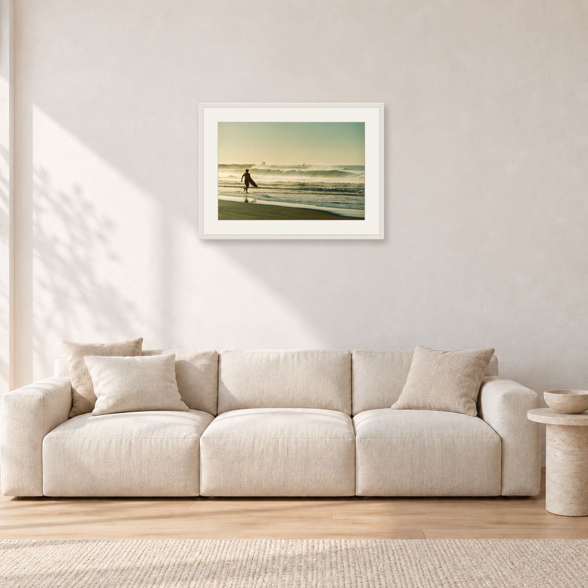 Narrabeen Surfer Fish, Dawn 1991 by Peter Crawford — 60 × 40 cm, white frame with white mat, shown in a light minimalist living room.