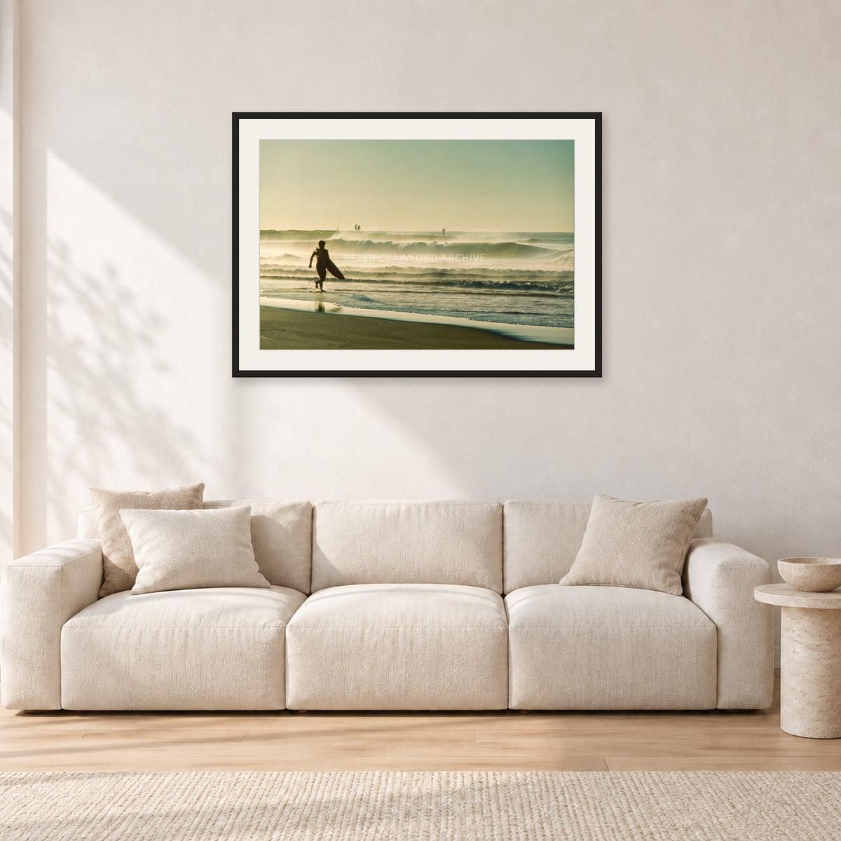 Narrabeen Surfer Fish, Dawn 1991 by Peter Crawford — 90 × 60 cm, black frame with white mat, shown in a light minimalist living room.