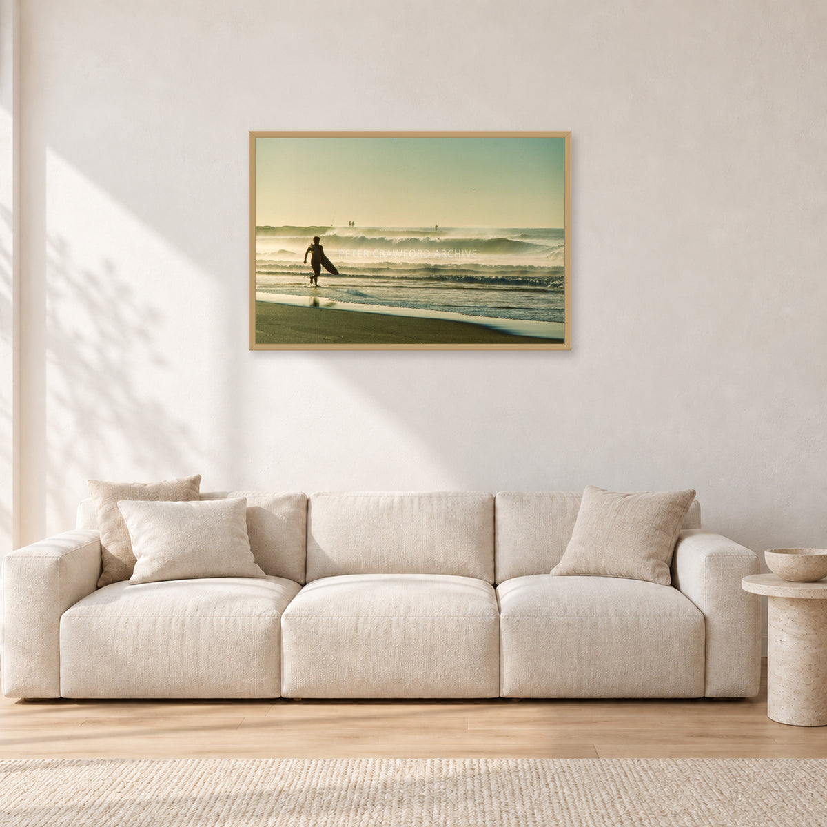 Narrabeen Surfer Fish, Dawn 1991 by Peter Crawford — 90 × 60 cm, hayseed frame, shown in a light minimalist living room.