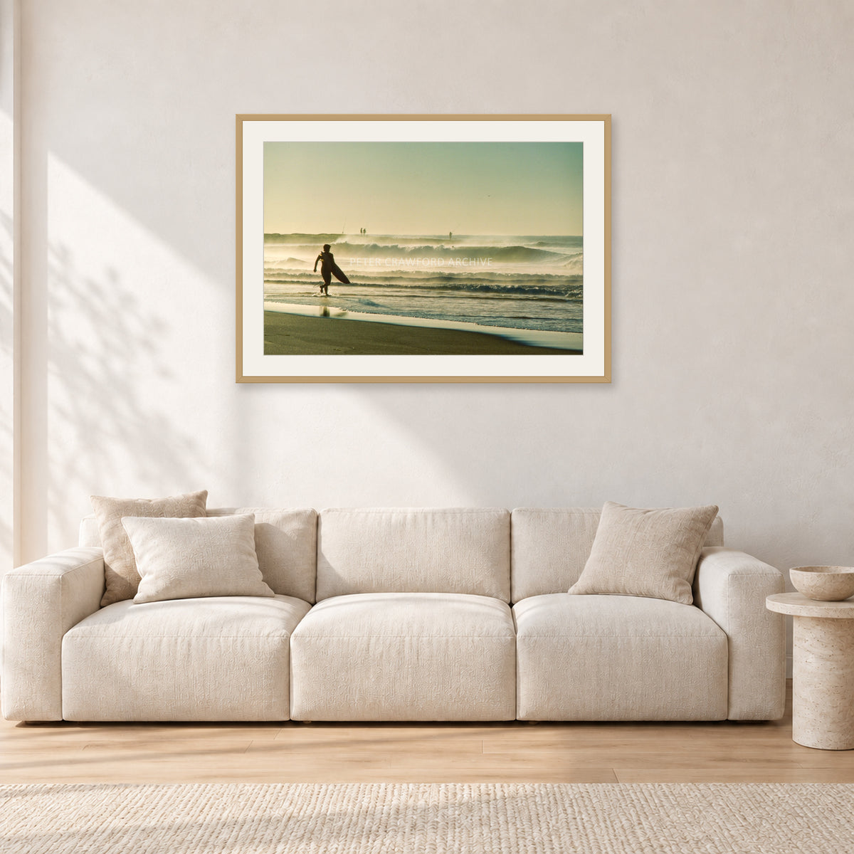 Narrabeen Surfer Fish, Dawn 1991 by Peter Crawford — 90 × 60 cm, hayseed frame with white mat, shown in a light minimalist living room.