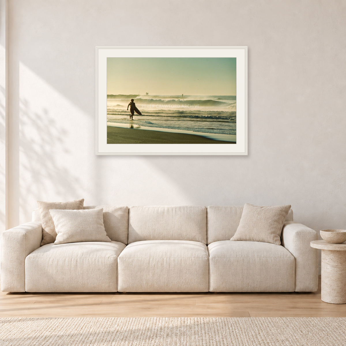 Narrabeen Surfer Fish, Dawn 1991 by Peter Crawford — 90 × 60 cm, white frame with white mat, shown in a light minimalist living room.