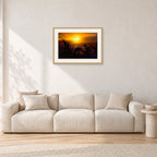 North Shore Sunset by Peter Crawford — 60 × 40 cm, hayseed frame with white mat, shown in a light minimalist living room.