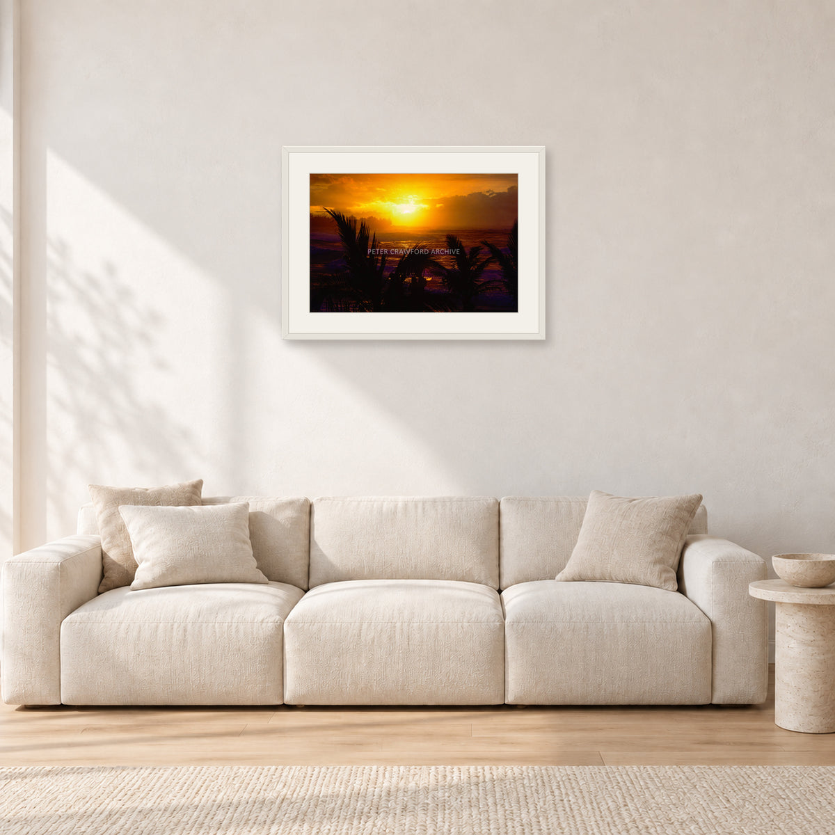 North Shore Sunset by Peter Crawford — 60 × 40 cm, white frame with white mat, shown in a light minimalist living room.