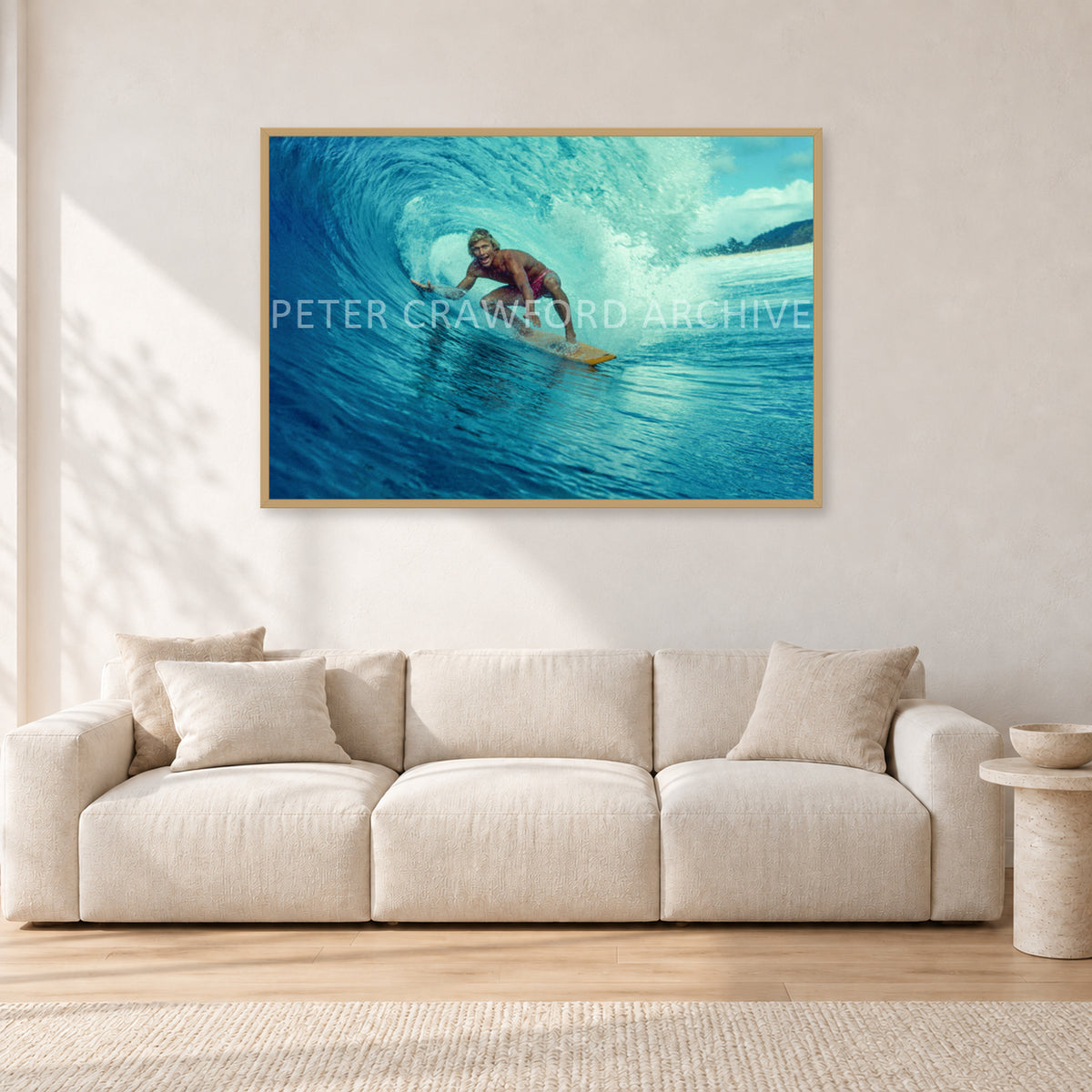 North Shore Tube Ride, Hawaii 1970s by Peter Crawford — 120 × 80 cm, hayseed frame, shown in a light minimalist living room.