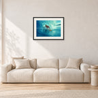 North Shore Tube Ride, Hawaii 1970s by Peter Crawford — 60 × 40 cm, black frame with white mat, shown in a light minimalist living room.
