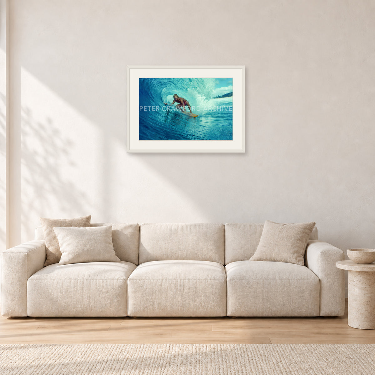 North Shore Tube Ride, Hawaii 1970s by Peter Crawford — 60 × 40 cm, white frame with white mat, shown in a light minimalist living room.