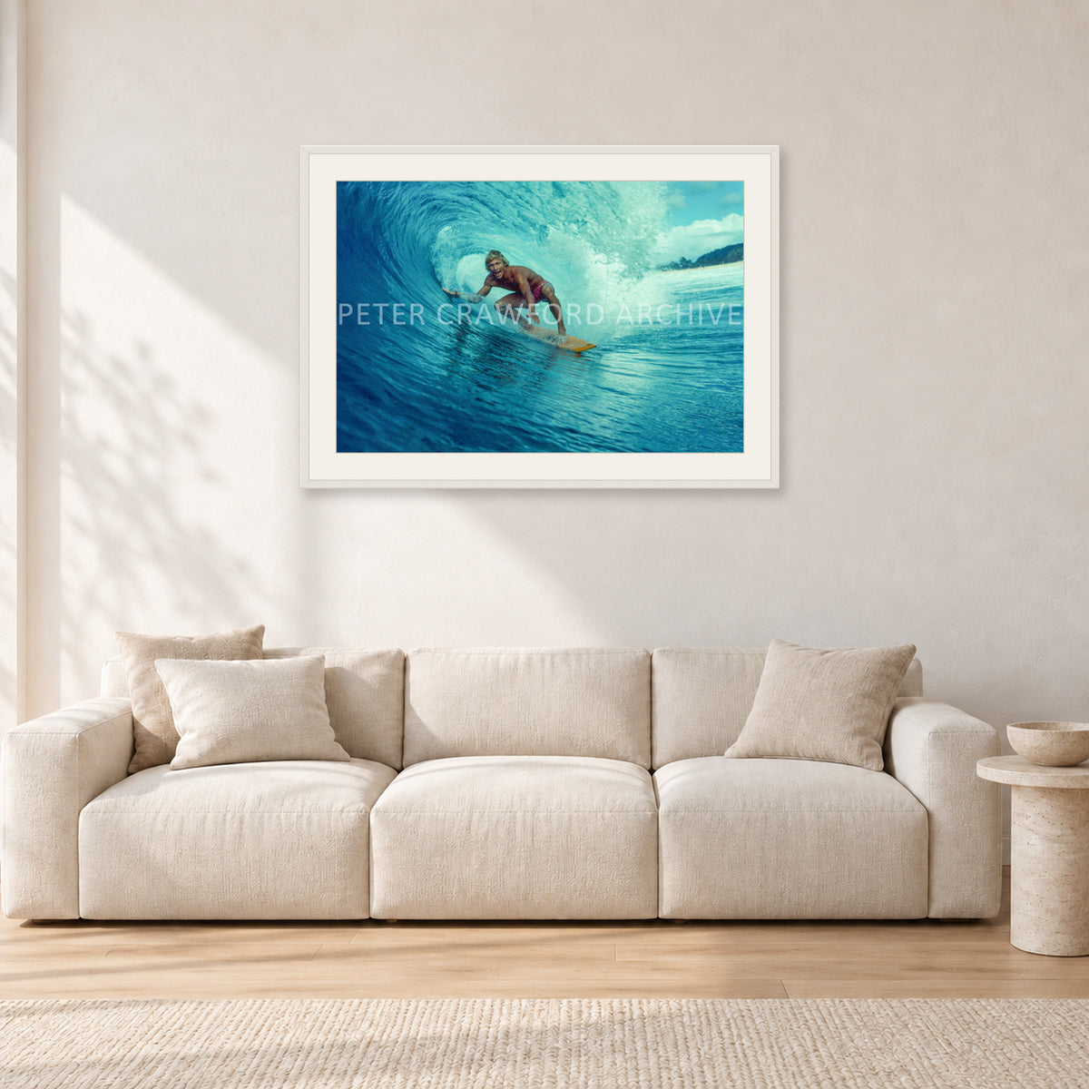 North Shore Tube Ride, Hawaii 1970s by Peter Crawford — 90 × 60 cm, white frame with white mat, shown in a light minimalist living room.