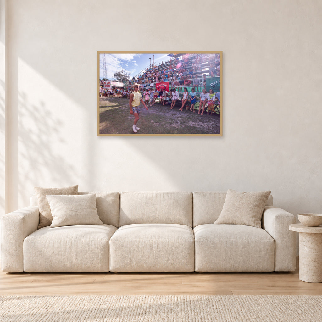Occy, Duranbah by Peter Crawford — 90 × 60 cm, hayseed frame, shown in a light minimalist living room.