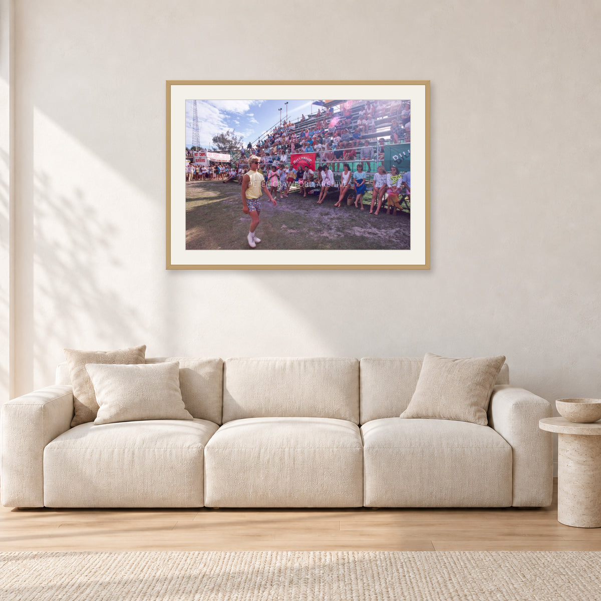 Occy, Duranbah by Peter Crawford — 90 × 60 cm, hayseed frame with white mat, shown in a light minimalist living room.