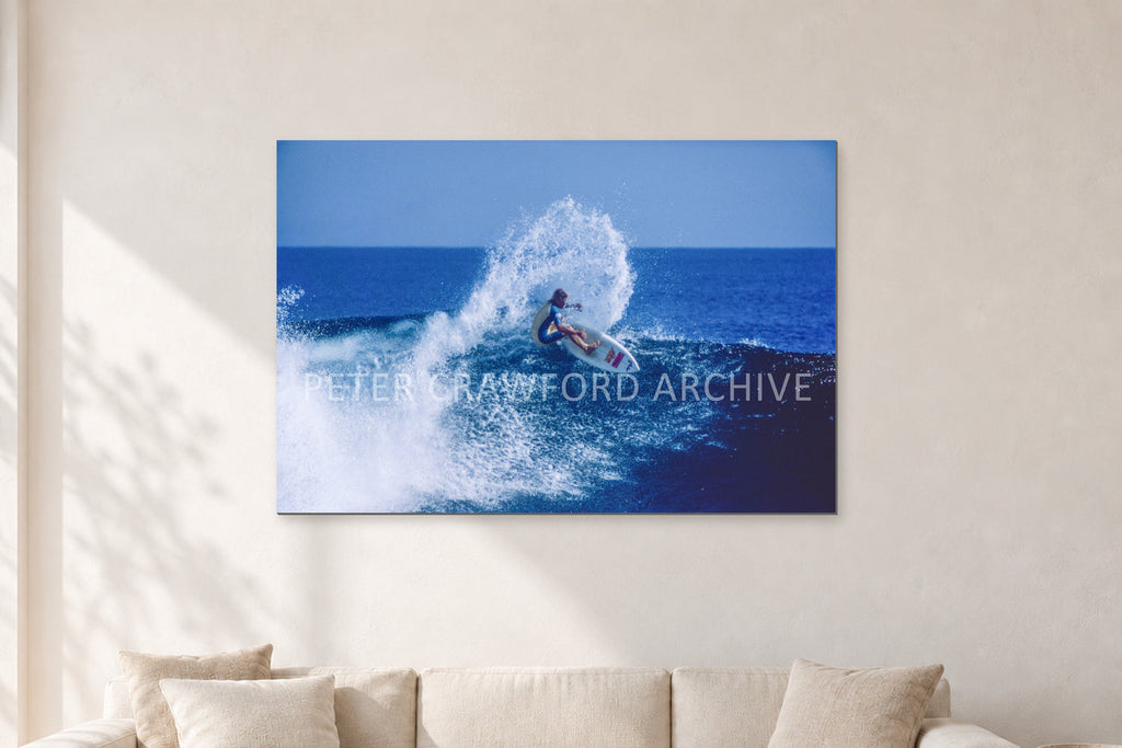 Occy, Top Turn 1984 by Peter Crawford — 120 × 80 cm, aluminium-mounted resin print, shown in a light minimalist living room.