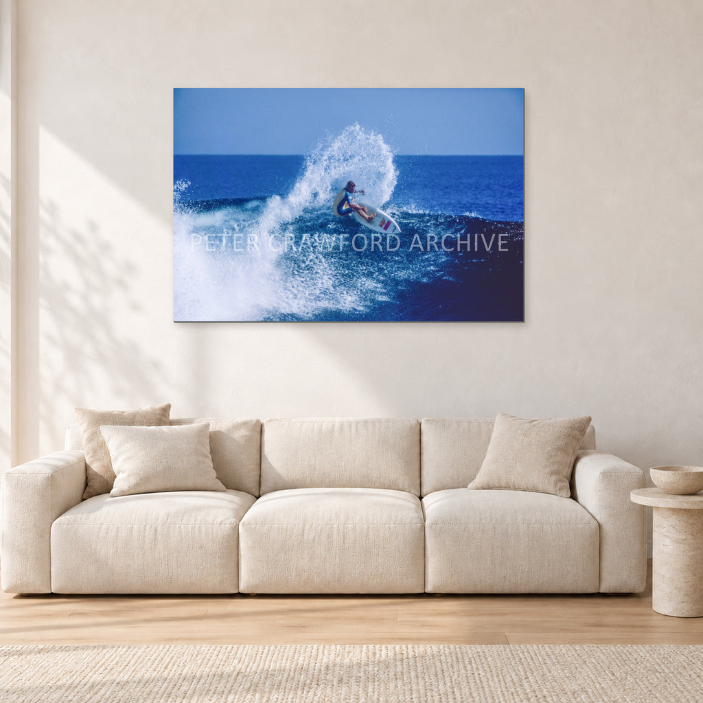 Occy, Top Turn 1984 by Peter Crawford — 120 × 80 cm, aluminium-mounted resin print, shown in a light minimalist living room.