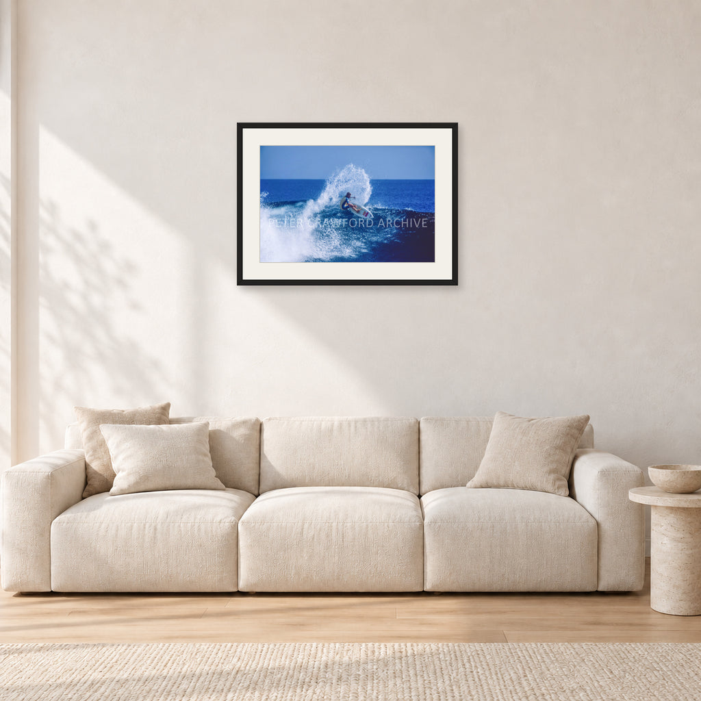 Occy, Top Turn 1984 by Peter Crawford — 60 × 40 cm, black frame with white mat, shown in a light minimalist living room.