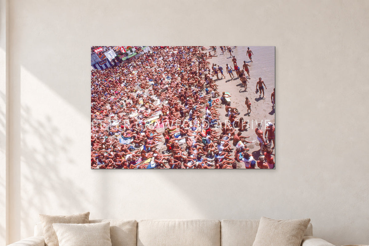 Op Pro Crowd 85 by Peter Crawford — 120 × 80 cm, aluminium-mounted resin print, shown in a light minimalist living room.