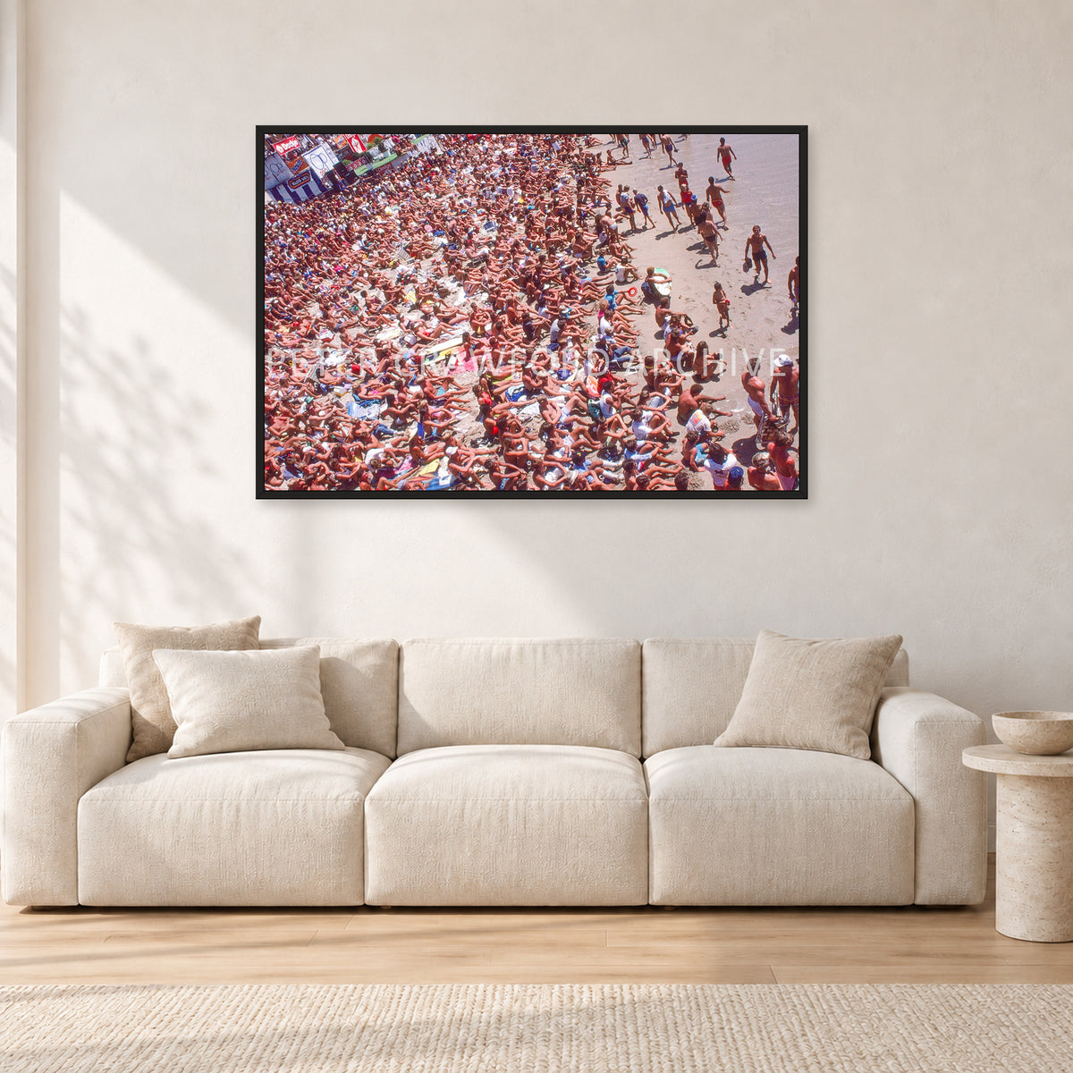 Op Pro Crowd 85 by Peter Crawford — 120 × 80 cm, black frame, shown in a light minimalist living room.