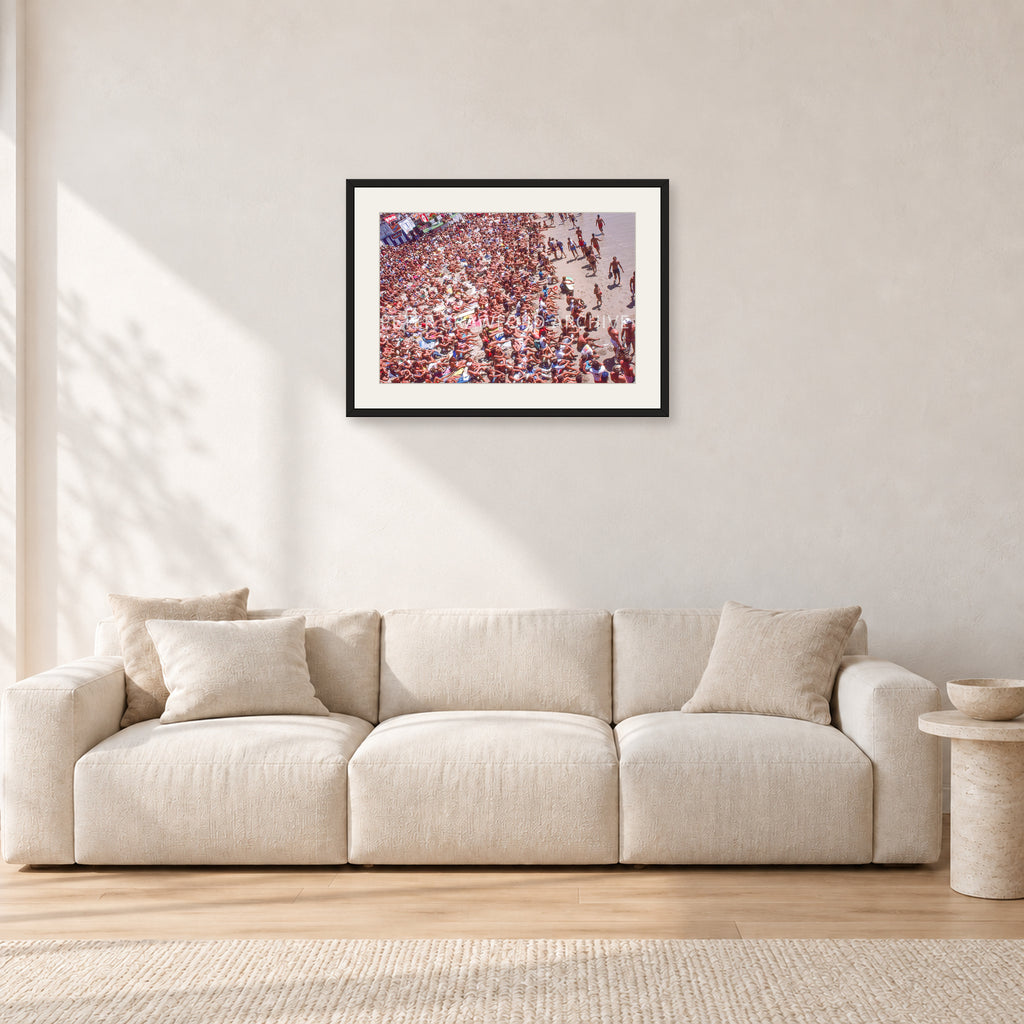 Op Pro Crowd 85 by Peter Crawford — 60 × 40 cm, black frame with white mat, shown in a light minimalist living room.