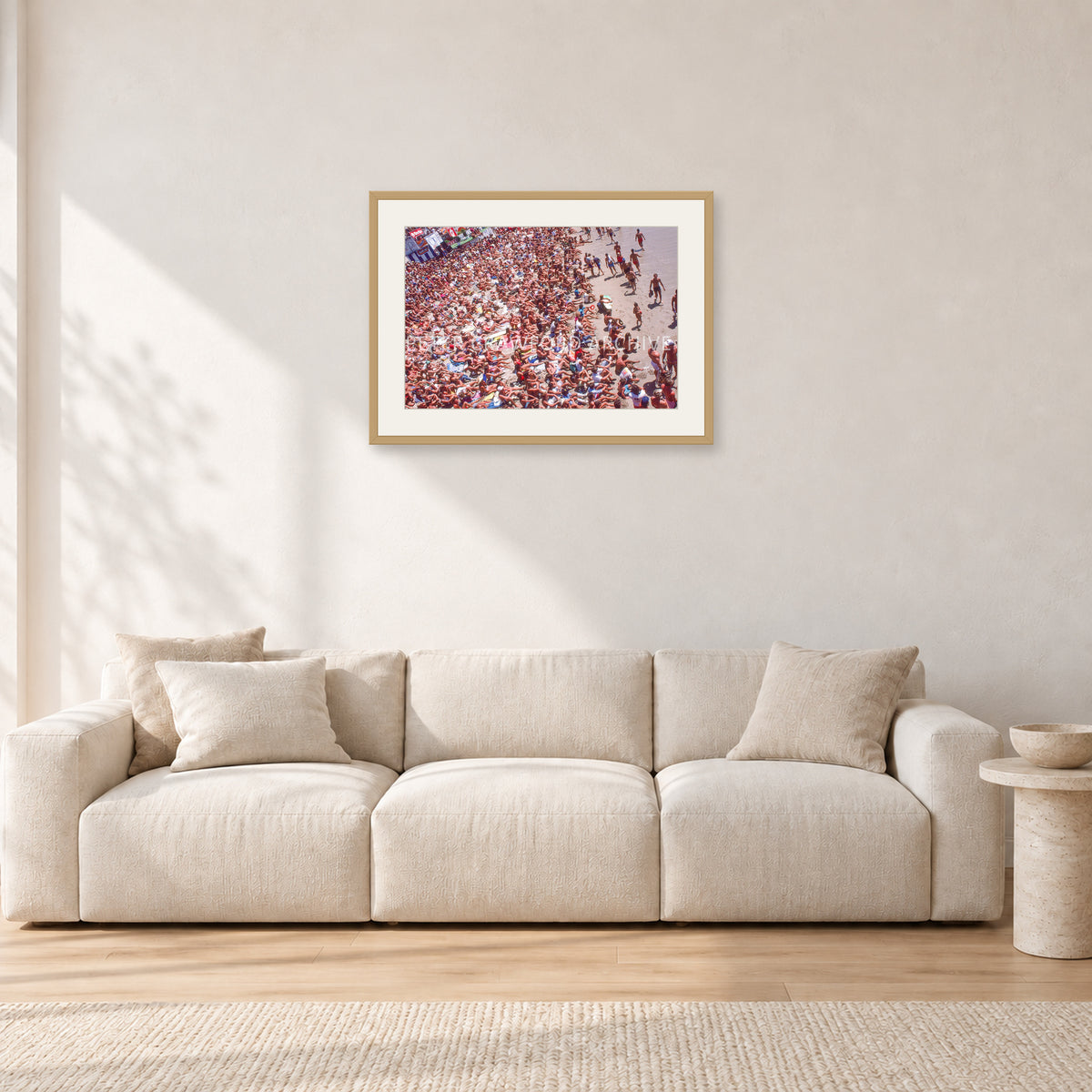 Op Pro Crowd 85 by Peter Crawford — 60 × 40 cm, hayseed frame with white mat, shown in a light minimalist living room.