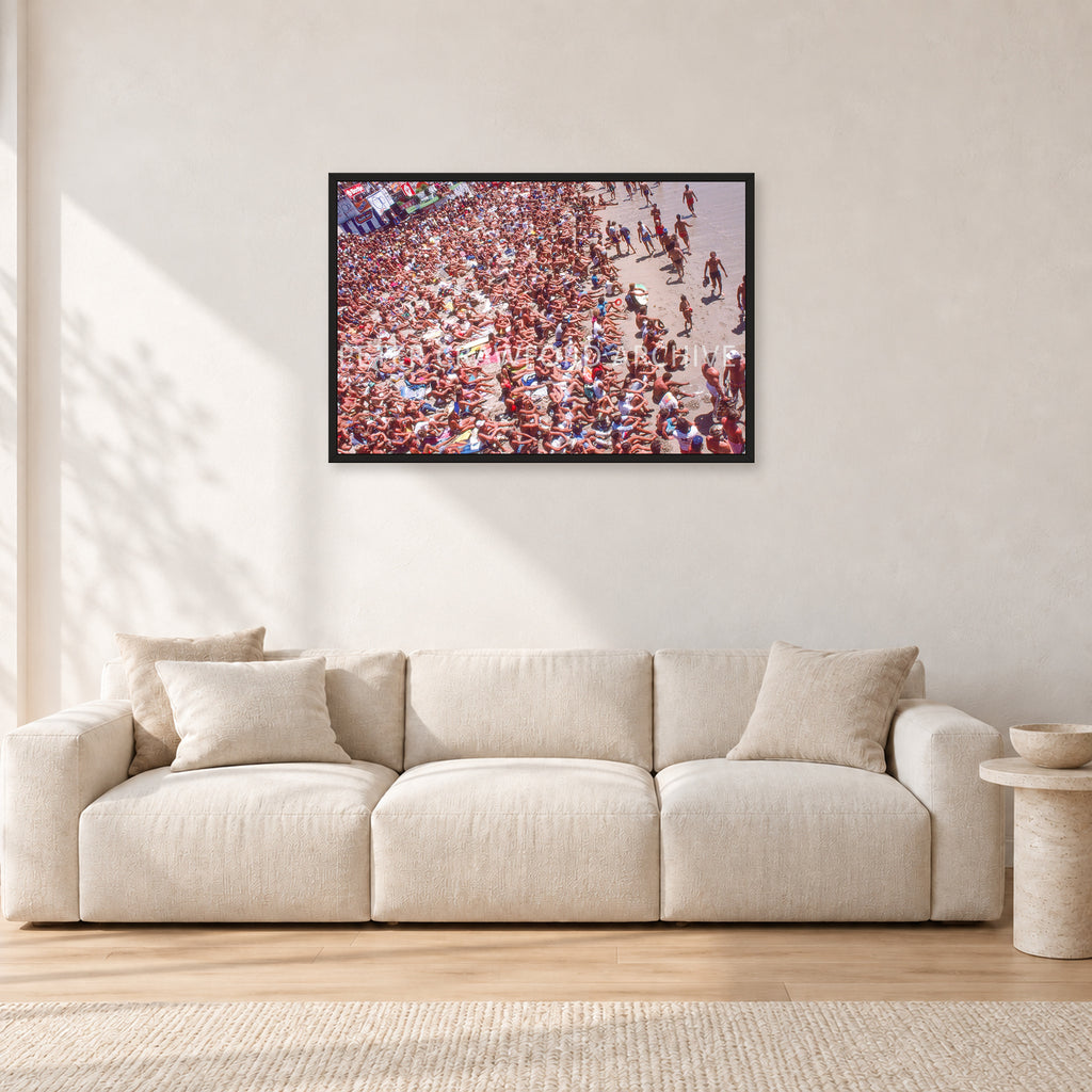 Op Pro Crowd 85 by Peter Crawford — 90 × 60 cm, black frame, shown in a light minimalist living room.