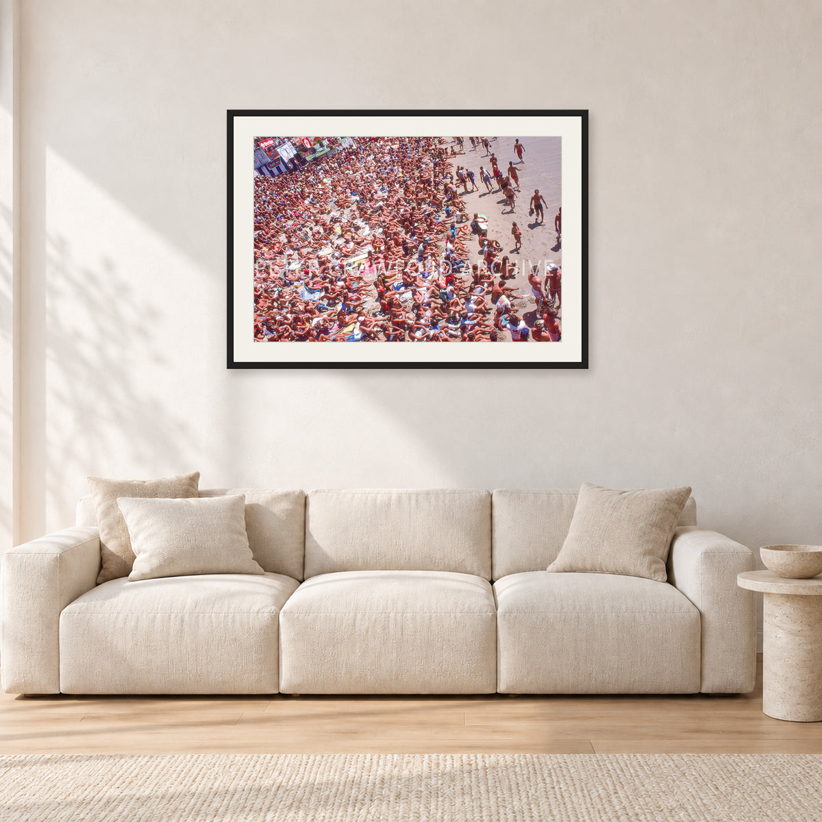 Op Pro Crowd 85 by Peter Crawford — 90 × 60 cm, black frame with white mat, shown in a light minimalist living room.