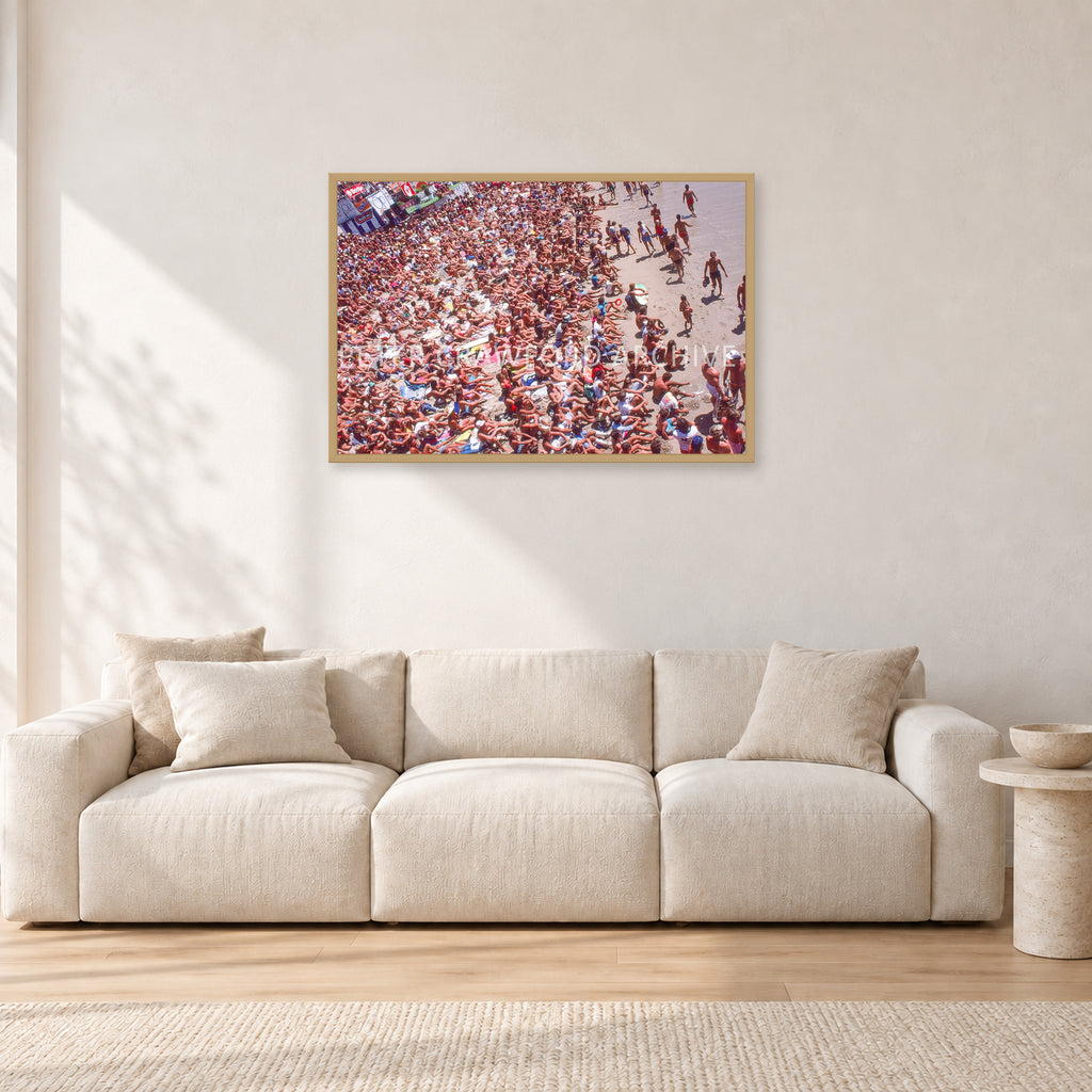 Op Pro Crowd 85 by Peter Crawford — 90 × 60 cm, hayseed frame, shown in a light minimalist living room.