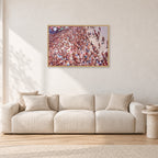 Op Pro Crowd 85 by Peter Crawford — 90 × 60 cm, hayseed frame, shown in a light minimalist living room.