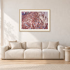 Op Pro Crowd 85 by Peter Crawford — 90 × 60 cm, hayseed frame with white mat, shown in a light minimalist living room.
