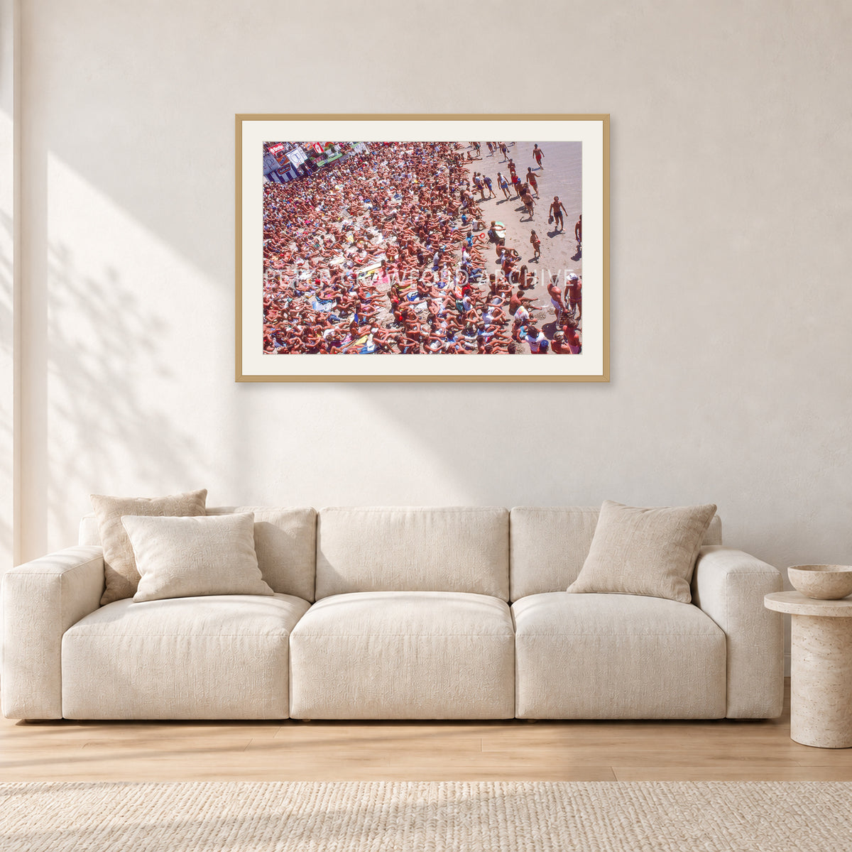 Op Pro Crowd 85 by Peter Crawford — 90 × 60 cm, hayseed frame with white mat, shown in a light minimalist living room.