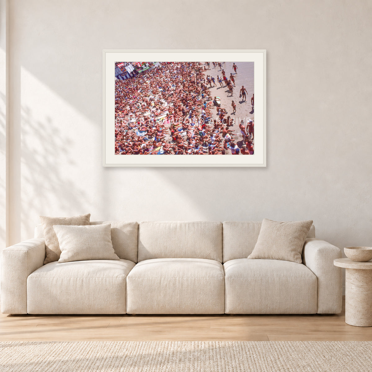 Op Pro Crowd 85 by Peter Crawford — 90 × 60 cm, white frame with white mat, shown in a light minimalist living room.