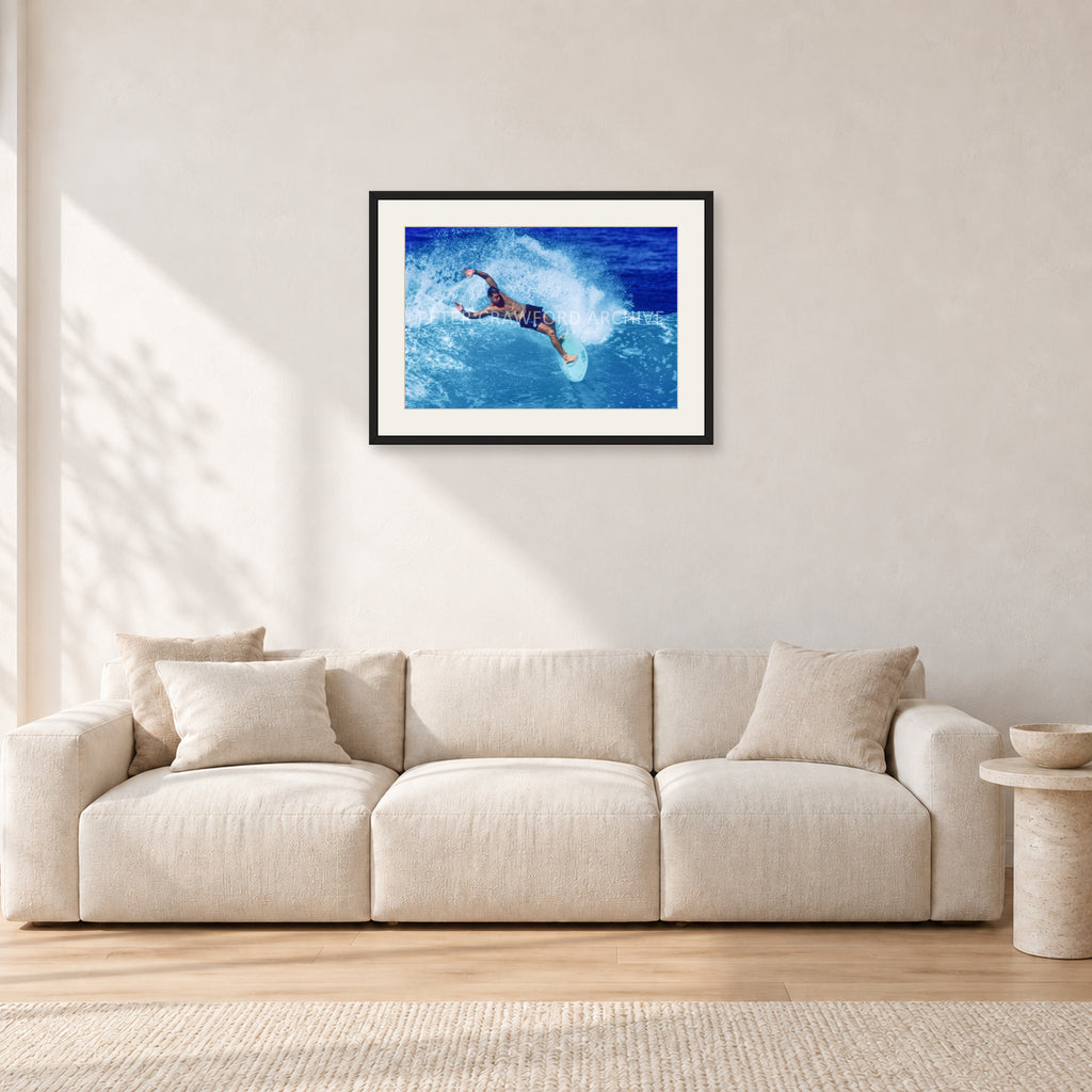 Paul Burnett, Hawaii 1989 by Peter Crawford — 60 × 40 cm, black frame with white mat, shown in a light minimalist living room.
