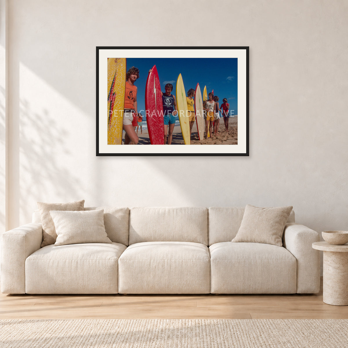 Pipe 76 Rory Russell Mike Armstrong Paul Naude by Peter Crawford — 90 × 60 cm, black frame with white mat, shown in a light minimalist living room.