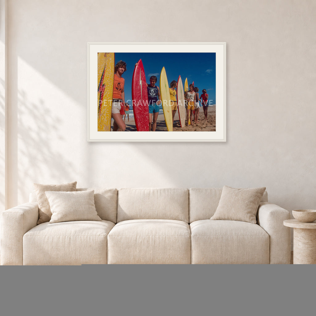 Pipe 76 Rory Russell Mike Armstrong Paul Naude by Peter Crawford — 90 × 60 cm, white frame with white mat, shown in a light minimalist living room.