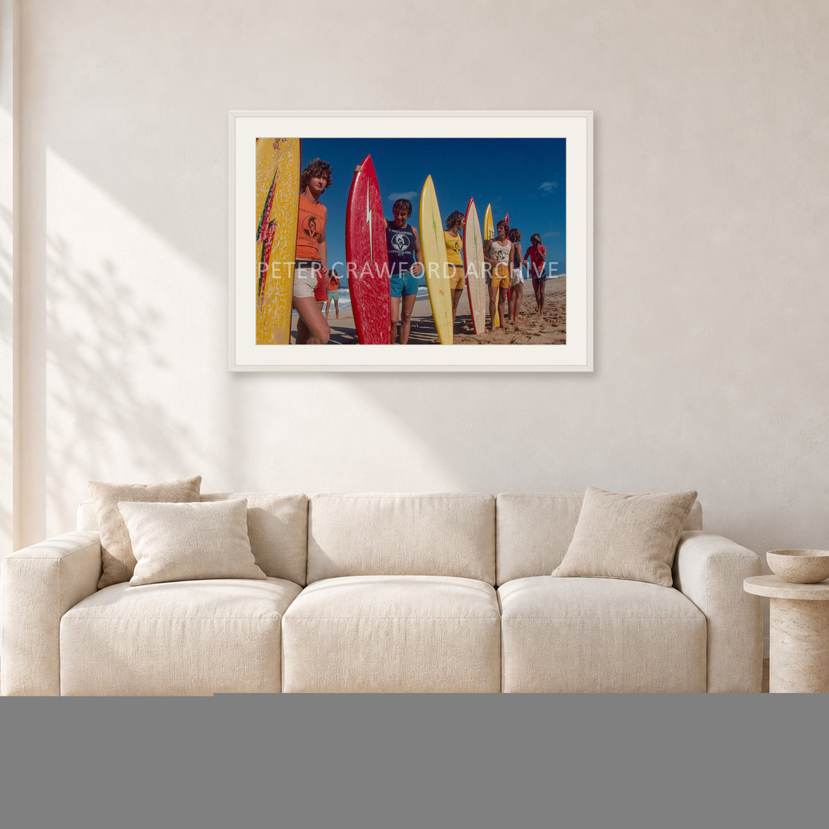 Pipe 76 Rory Russell Mike Armstrong Paul Naude by Peter Crawford — 90 × 60 cm, white frame with white mat, shown in a light minimalist living room.