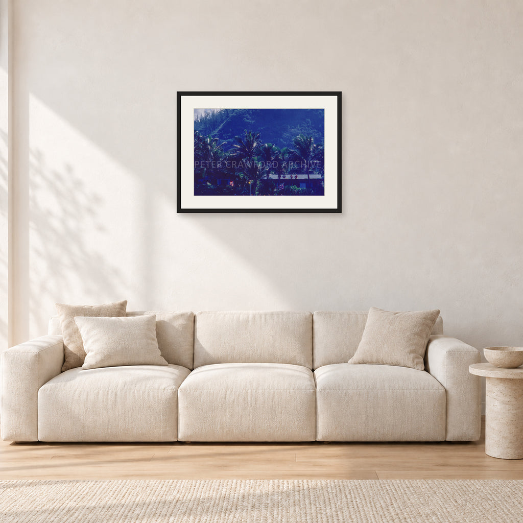 Pipe Final Crowd by Peter Crawford — 60 × 40 cm, black frame with white mat, shown in a light minimalist living room.