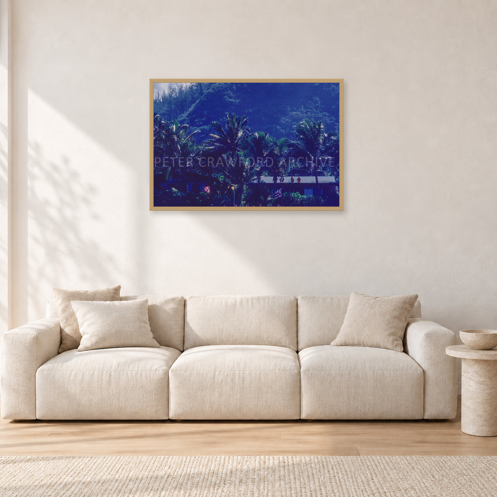 Pipe Final Crowd by Peter Crawford — 90 × 60 cm, hayseed frame, shown in a light minimalist living room.