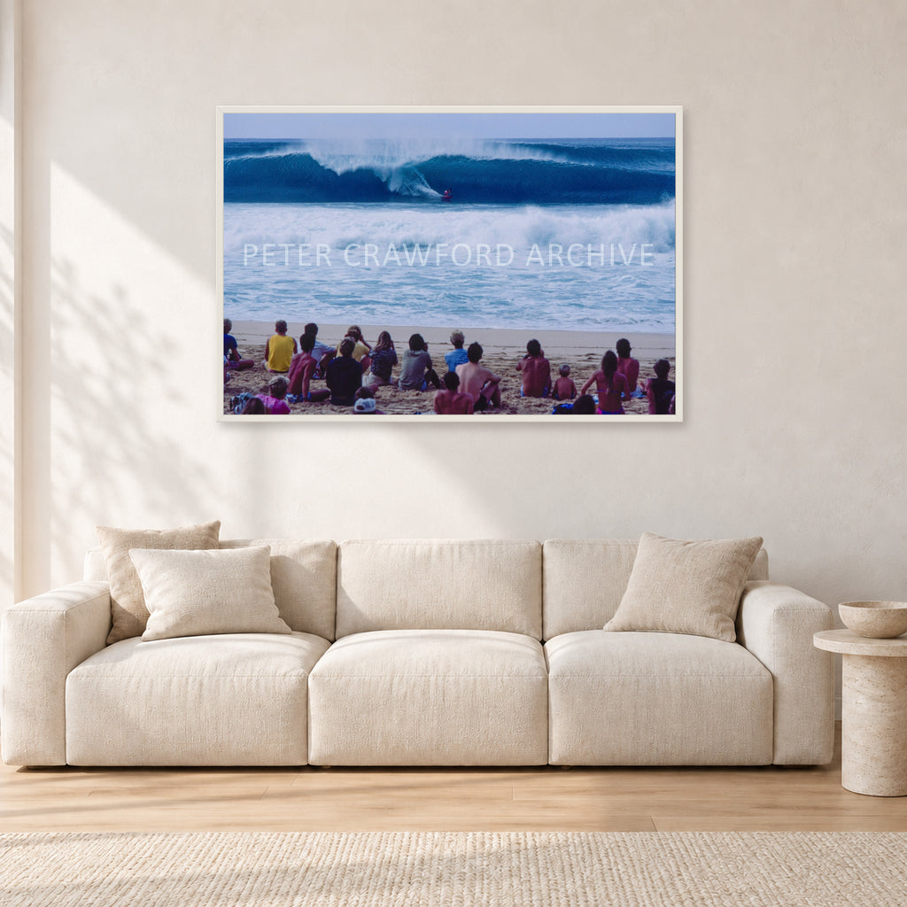 Pipe Masters, Pipeline 1988 by Peter Crawford — 120 × 80 cm, white frame, shown in a light minimalist living room.