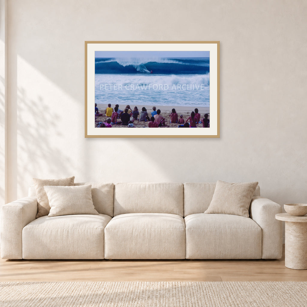 Pipe Masters, Pipeline 1988 by Peter Crawford — 90 × 60 cm, hayseed frame with white mat, shown in a light minimalist living room.