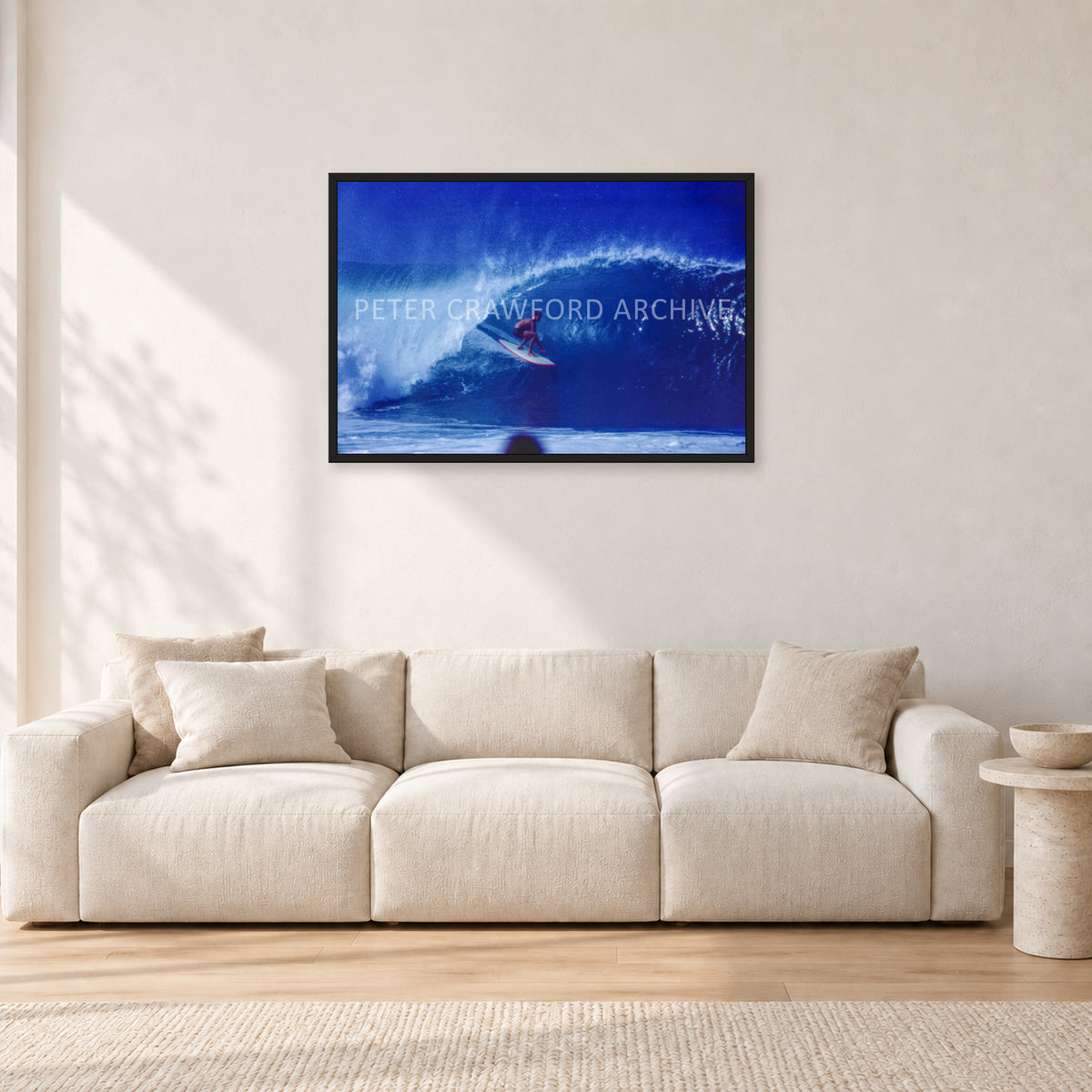 Pipeline, Hawaii by Peter Crawford — 90 × 60 cm, black frame, shown in a light minimalist living room.