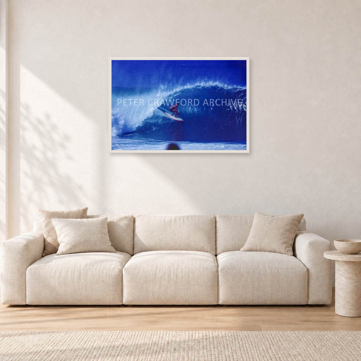 Pipeline, Hawaii by Peter Crawford — 90 × 60 cm, white frame, shown in a light minimalist living room.