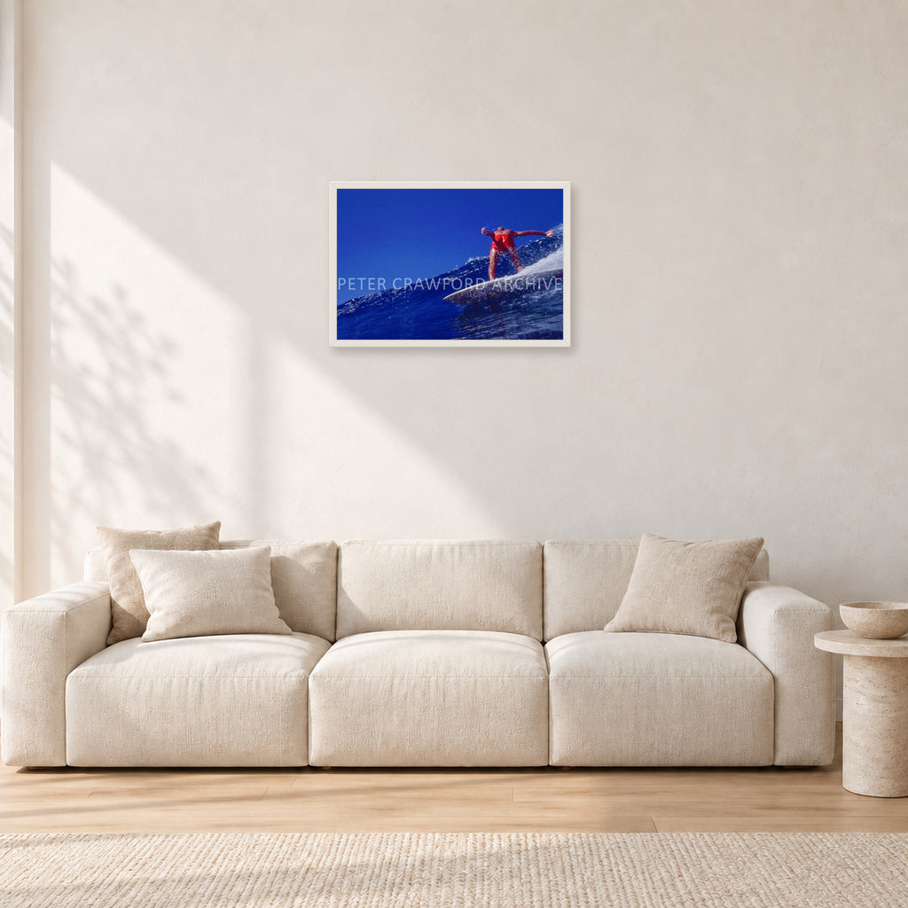 Rabbit Bartholomew, Stubbies 1978 by Peter Crawford — 60 × 40 cm, white frame, shown in a light minimalist living room.