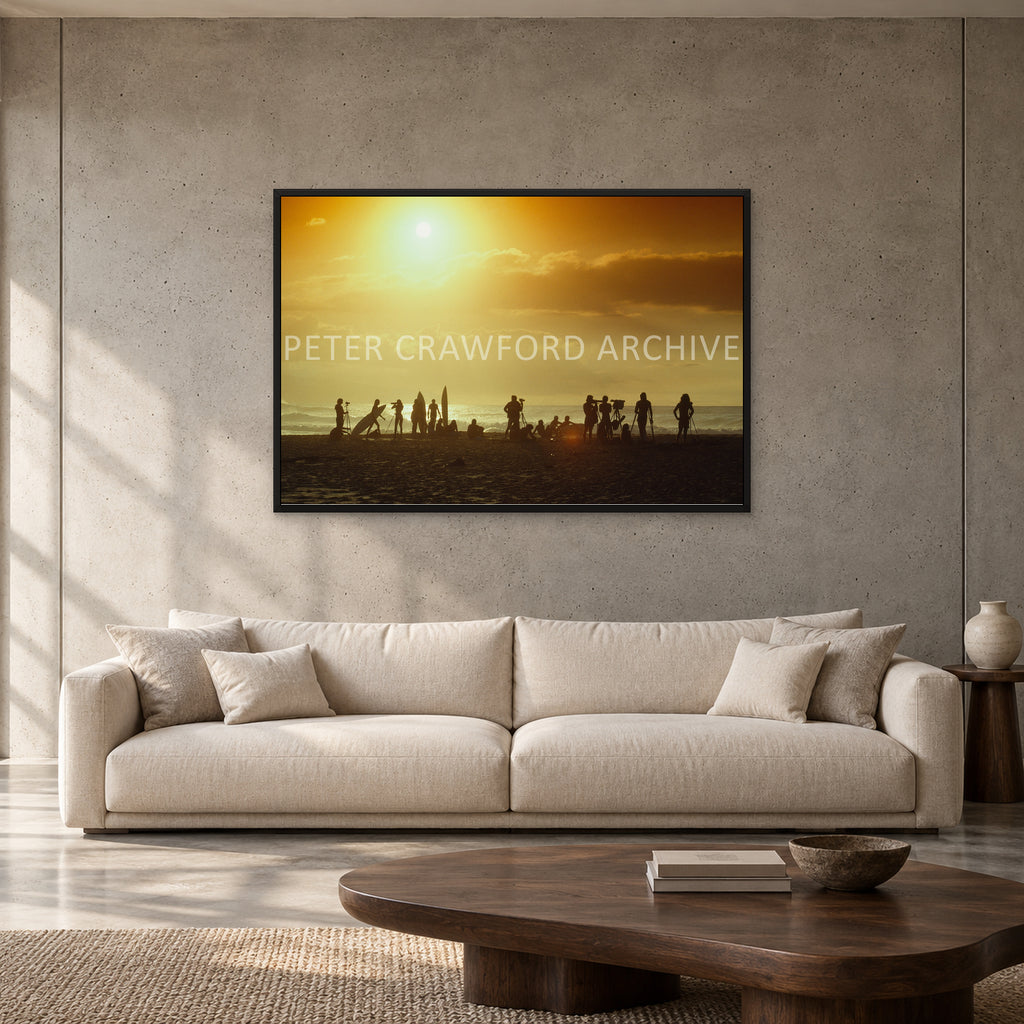North Shore Sunset by Peter Crawford — 120 × 80 cm, black full frame, shown to scale in a contemporary concrete-wall living room.
