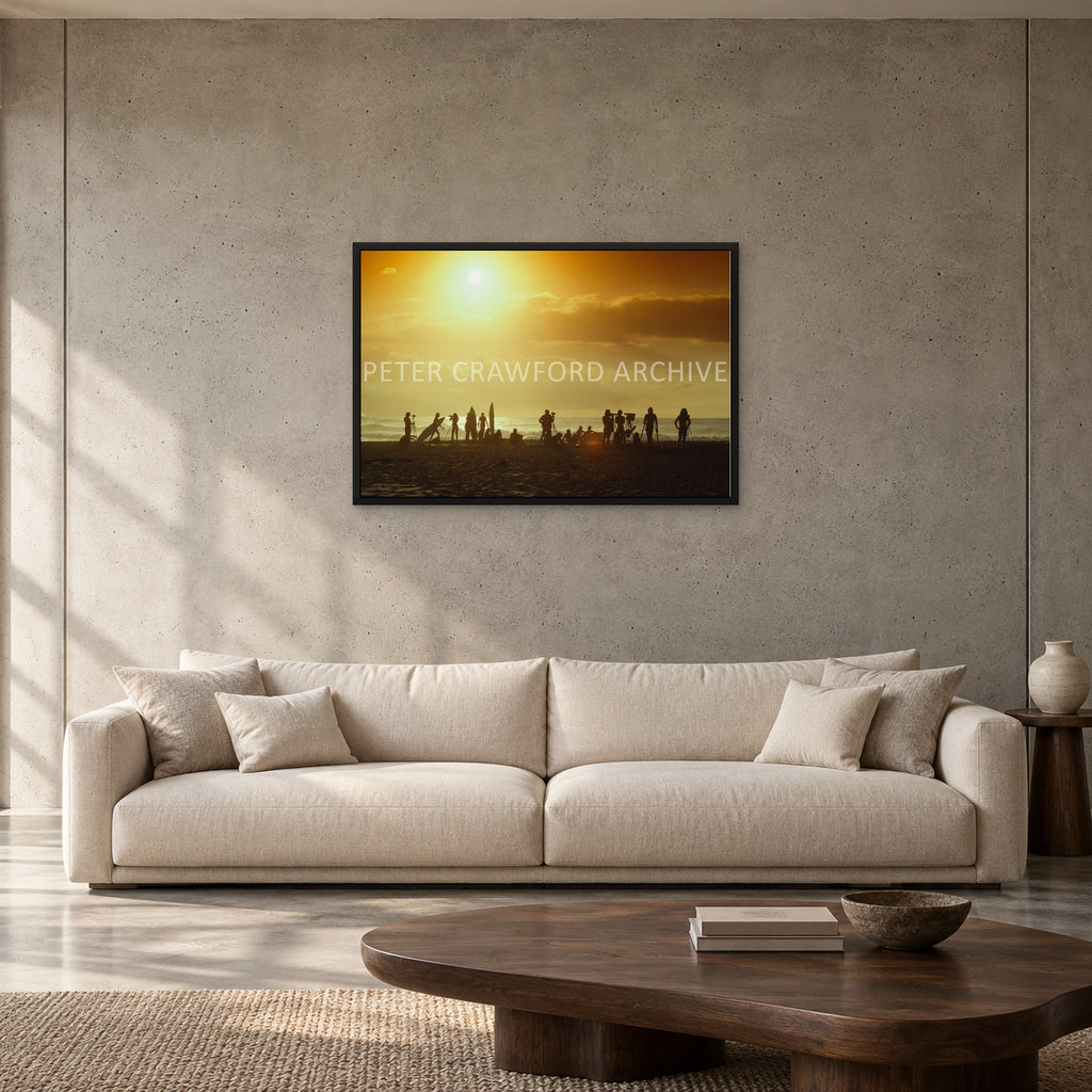 North Shore Sunset by Peter Crawford — 90 × 60 cm, black full frame, shown to scale in a contemporary concrete-wall living room.