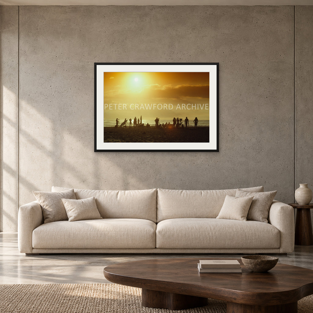 North Shore Sunset by Peter Crawford — 90 × 60 cm, black frame with mat, shown to scale in a contemporary concrete-wall living room.