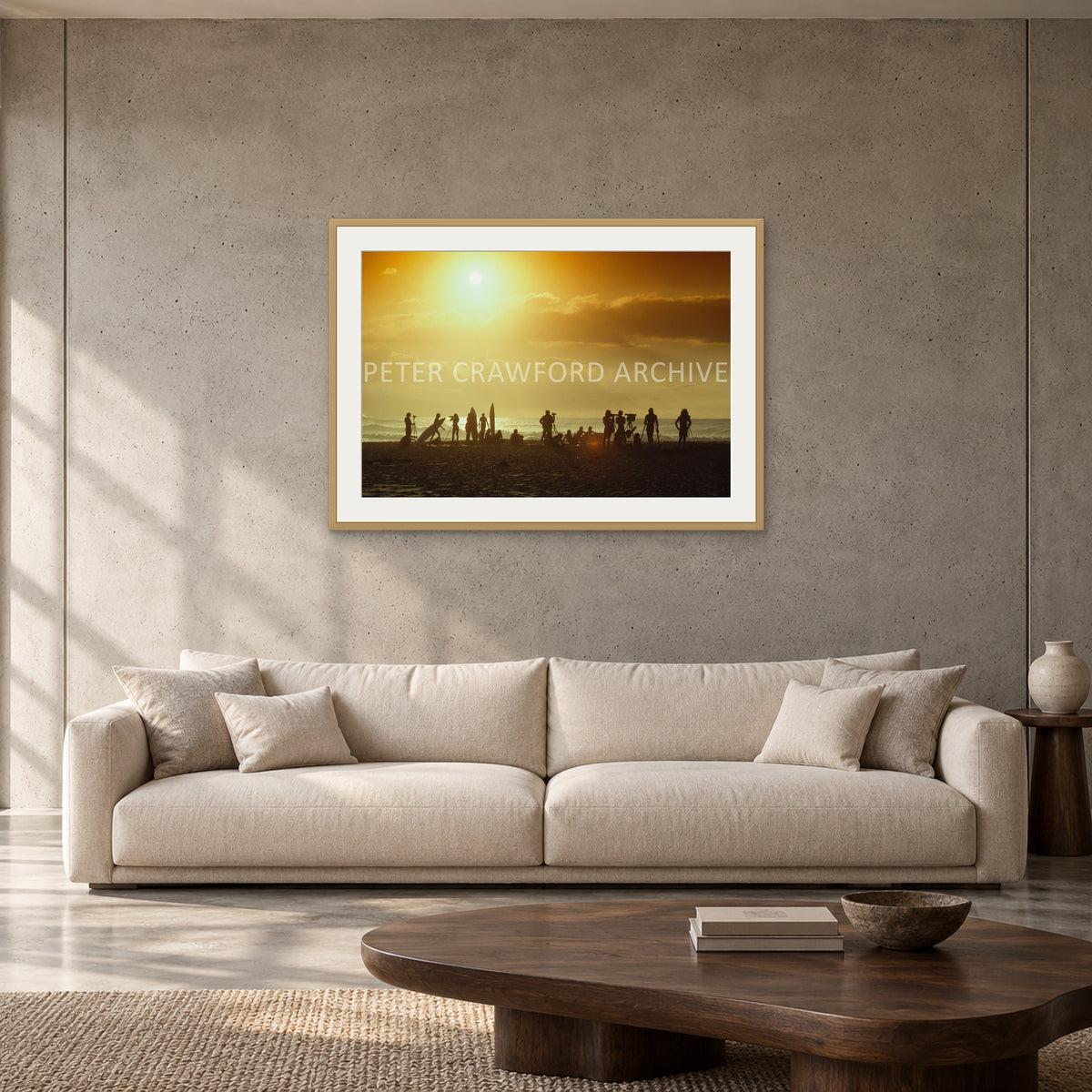 North Shore Sunset by Peter Crawford — 90 × 60 cm, hayseed frame with mat, shown to scale in a contemporary concrete-wall living room.